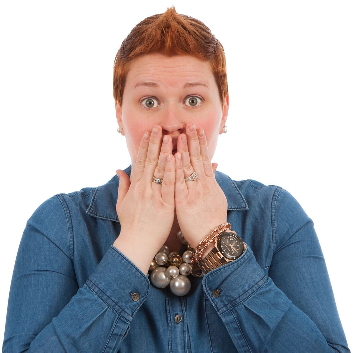 a woman with a surprised face with her hands covering her mouth